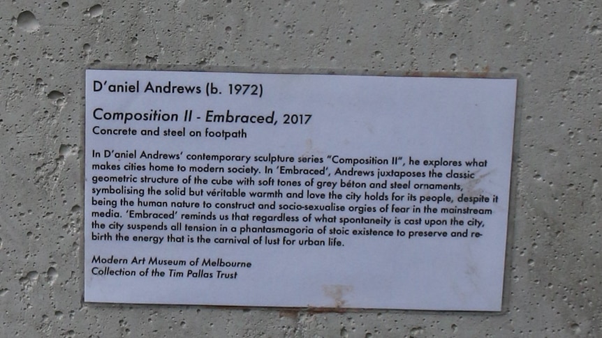 A humorous plaque on a concrete bollard in Melbourne's CBD.