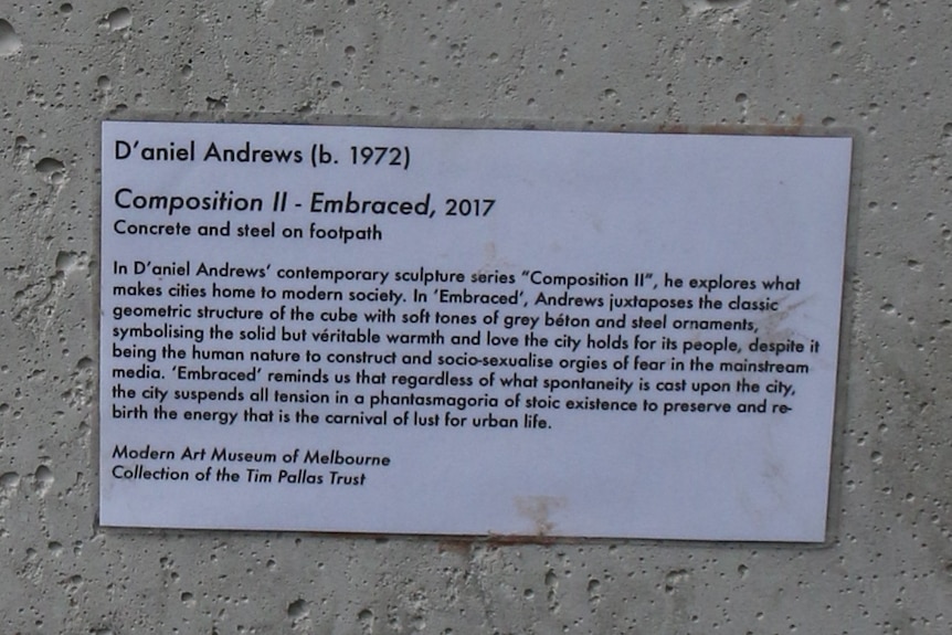A humorous plaque on a concrete bollard in Melbourne's CBD.