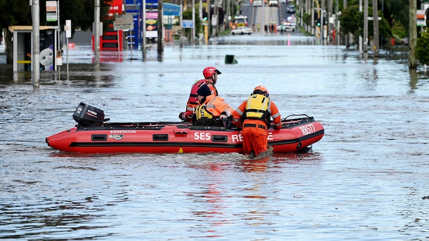 An SES rescue boat with three crew traverse floods in Maribyrnong, Melbourne.