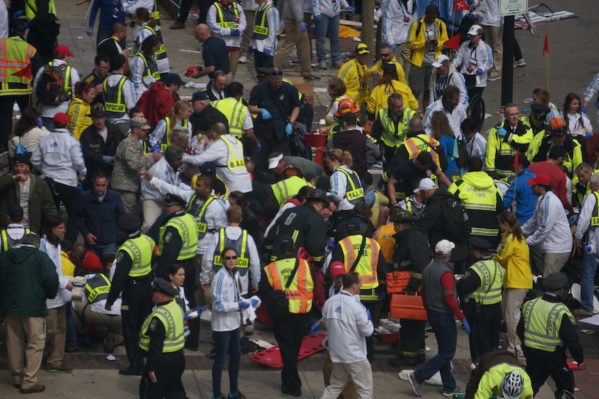 Medics attend to victims at the scene of the Boston marathon blast.