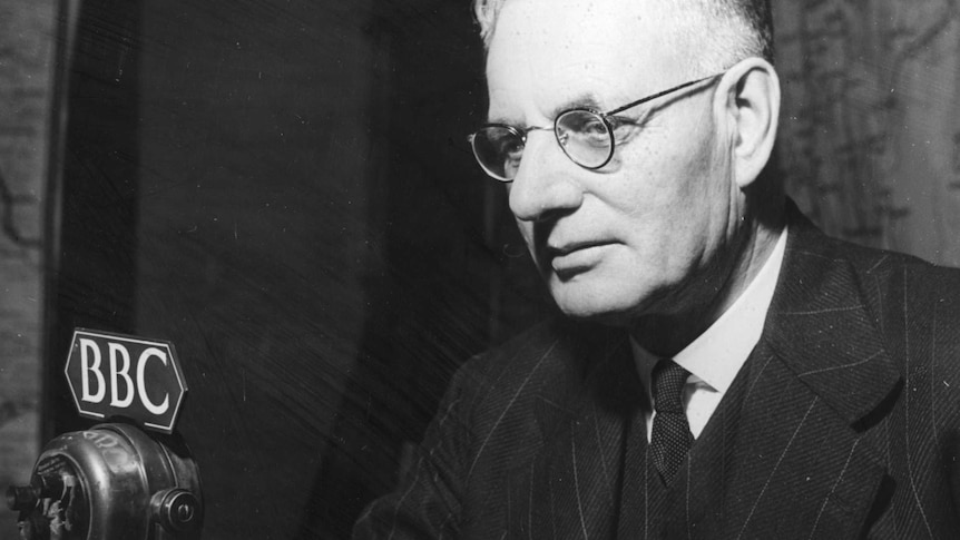 Prime Minister John Curtin (1885 - 1945), of Australia, in front of a microphone at the BBC in London.