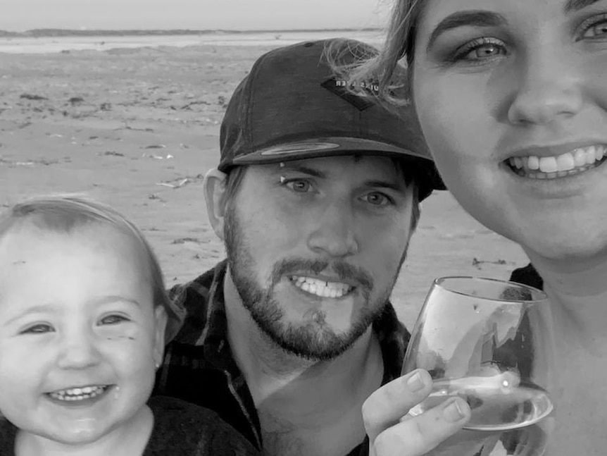 Black and white photo of a child, a man and a woman in headshot