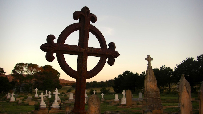 A rural graveyard at sunset.