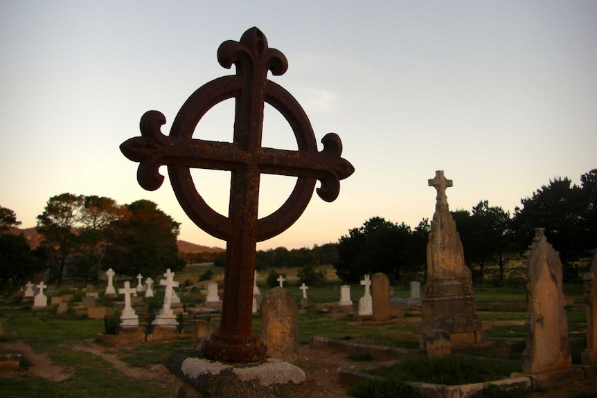 A rural graveyard at sunset.