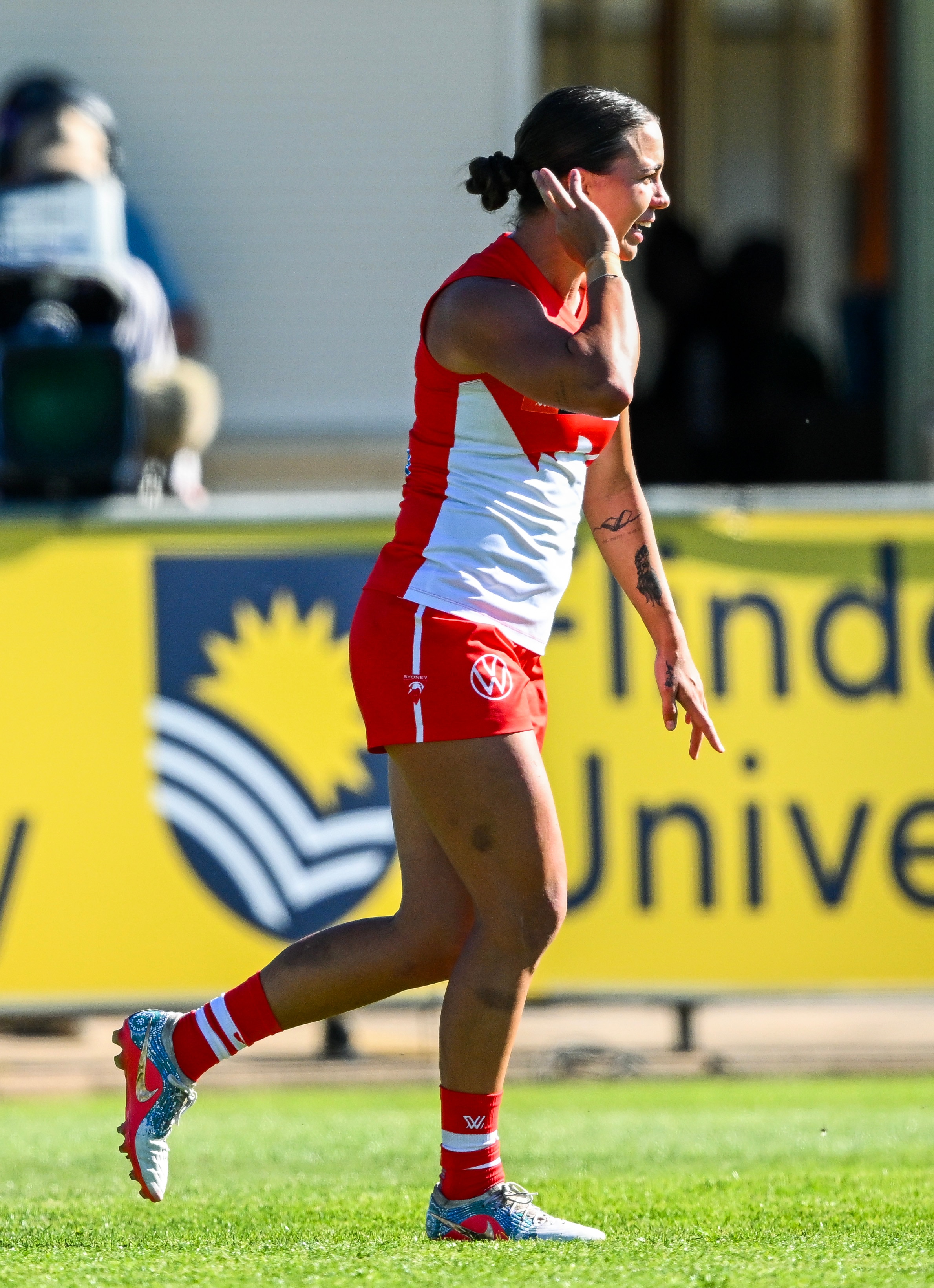 Chloe Molloy celebrates an AFLW goal for the Swans.