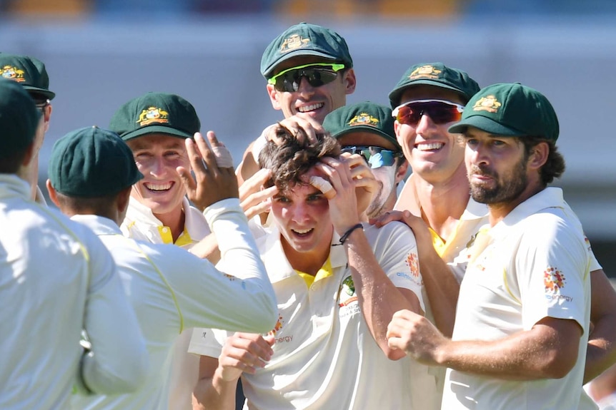 Jhye Richardson is mobbed by his Australian cricket teammates, who muss his hair during the first Test against Sri Lanka.