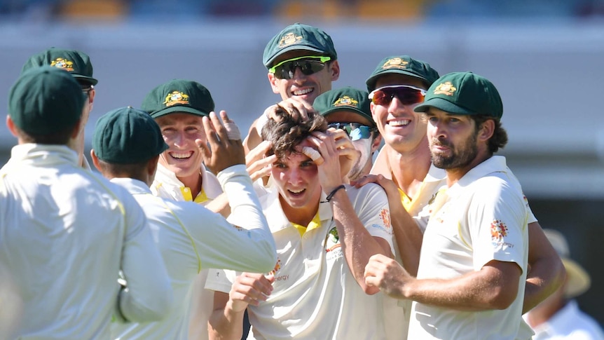 Jhye Richardson is mobbed by his Australian cricket teammates, who muss his hair during the first Test against Sri Lanka.