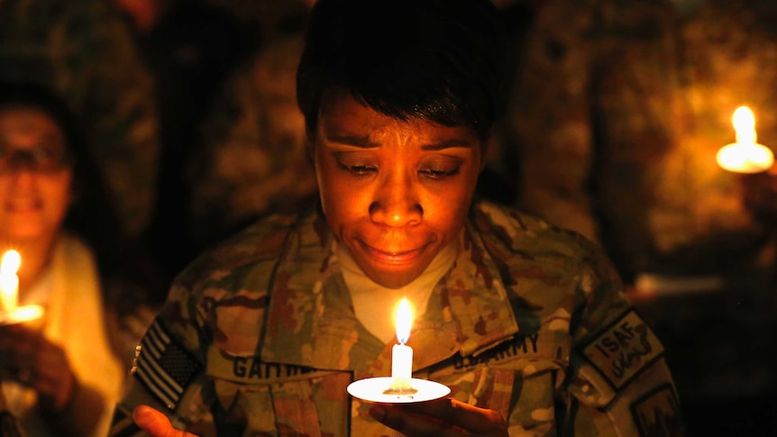 US soldier lights candle in Afghanistan
