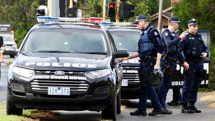 Police officers and police cars at Brighton the day after the fatal shooting incident.
