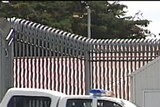 A police car leaves Ashley Youth Detention Centre in Tasmania after a detainee died.