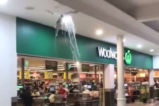 Water pours through a hole in the roof at the Morley Galleria shopping centre