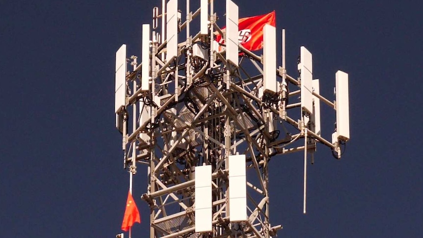 Nazi and China flags strung high on a telecoms tower.
