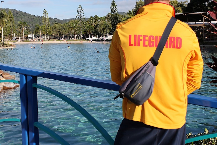 A lifeguard looks over a man-made lagoon.