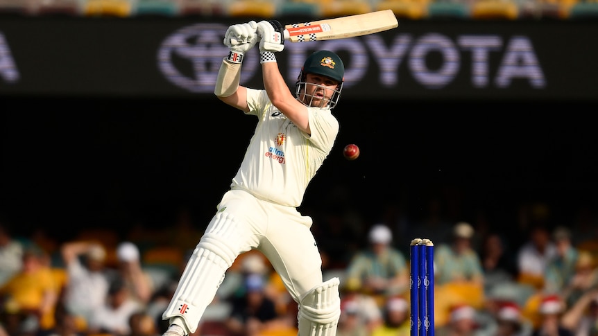 Australia batter Travis Head hits a cricket ball away during the first Test against South Africa at the Gabba.