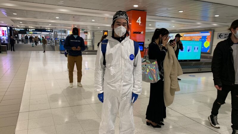 A man in full protective gear at an airport.