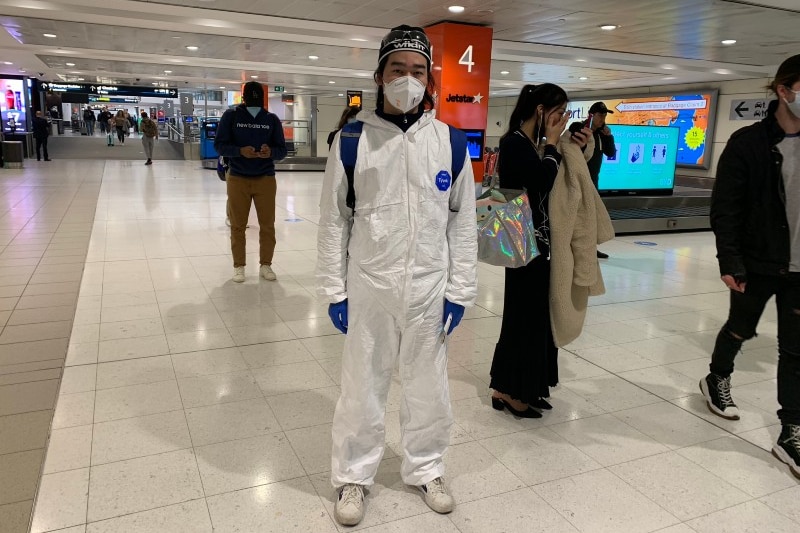 A man in full protective gear at an airport.