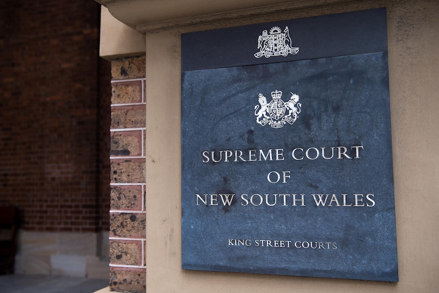 A sign which reads "Supreme Court of New South Wales, Kings Street Courts"