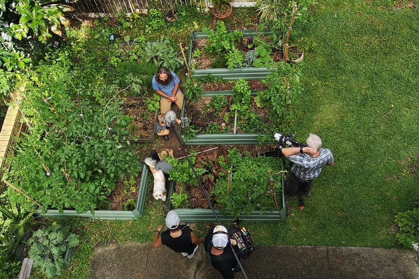 Looking down at a garden area with a film crew working