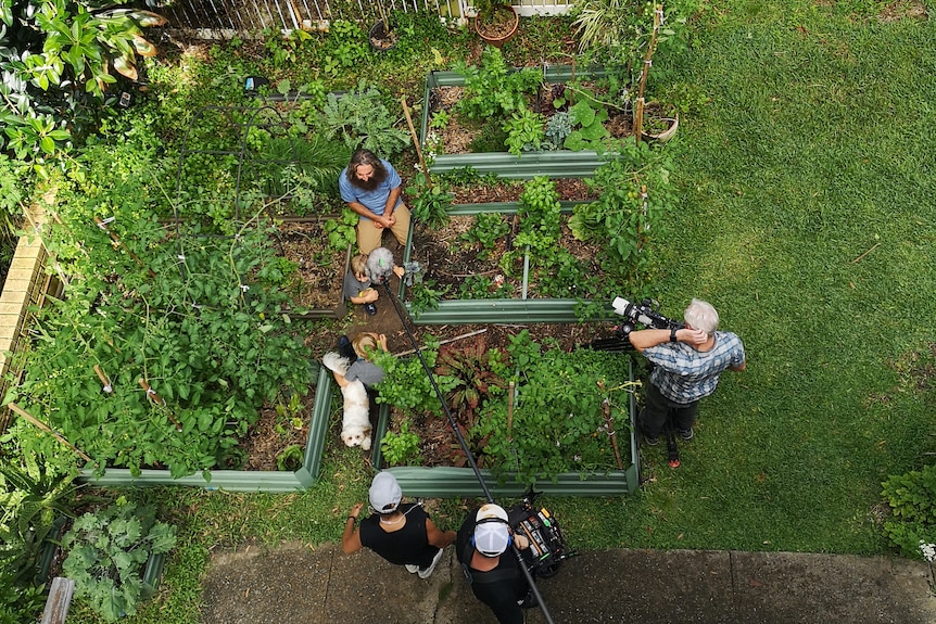 Looking down at a garden area with a film crew working