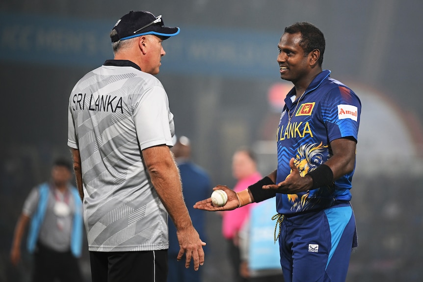 A man looks forlorn as he speaks to his coach.