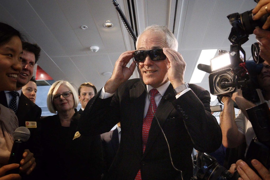 Malcolm Turnbull tries on glasses while visiting Engineers Australia.