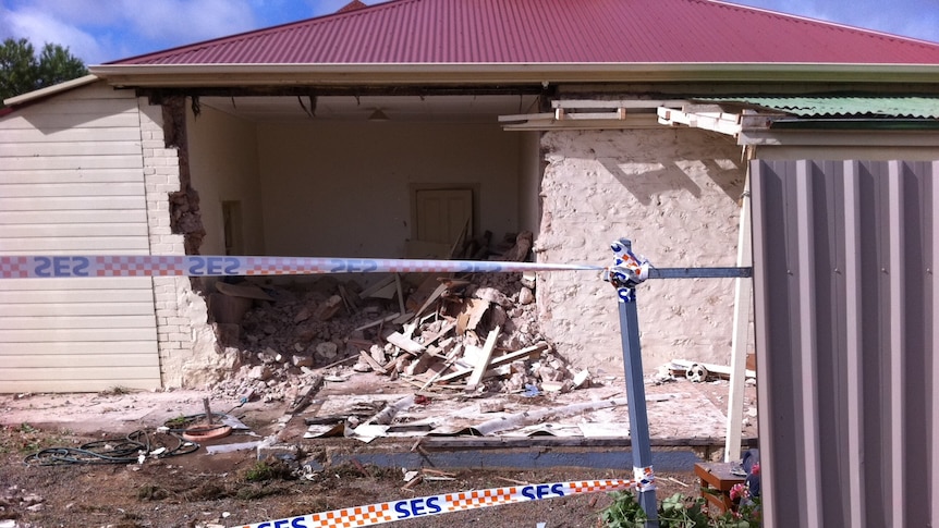 Hole in the wall of the house after the bus was removed