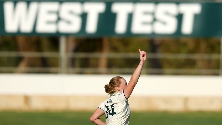 Australia bowler Kim Garth points to the sky as she celebrates a wicket in the Test against South Africa.