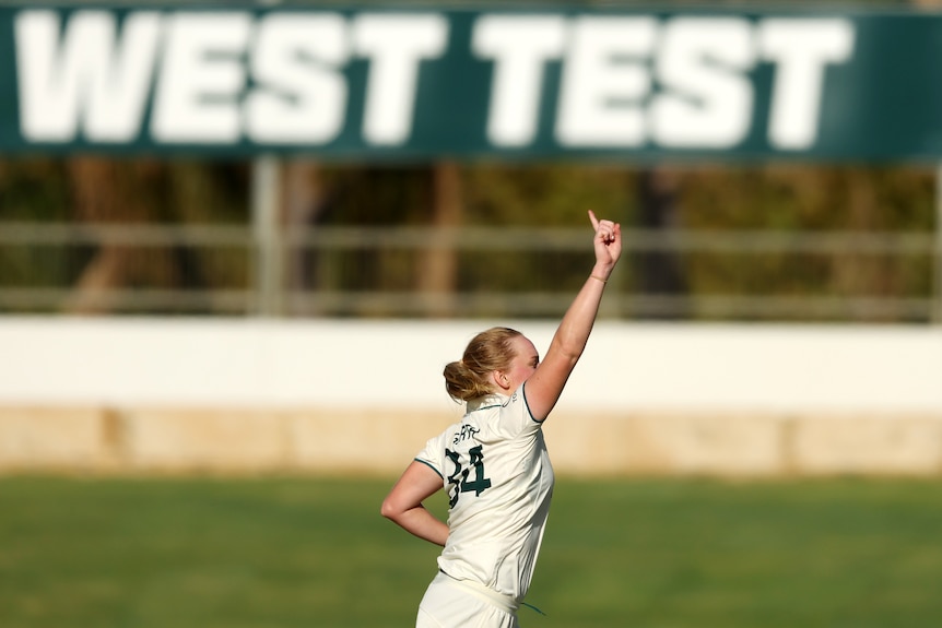 Australia bowler Kim Garth points to the sky as she celebrates a wicket in the Test against South Africa.