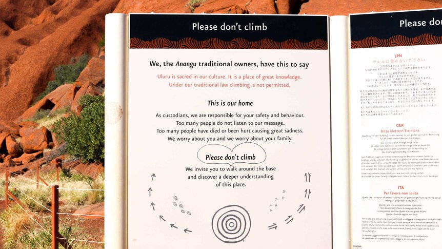 Anangu sign at the base of Uluru requesting that tourists don't climb the iconic rock