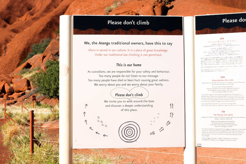 Anangu sign at the base of Uluru requesting that tourists don't climb the iconic rock