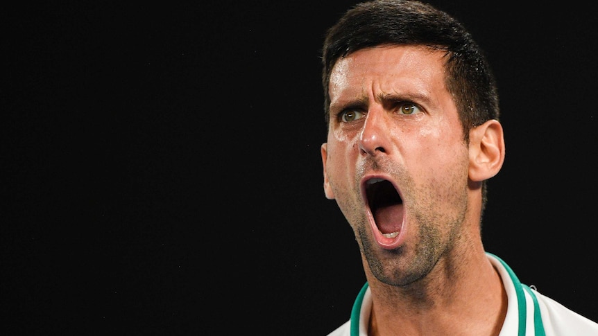 A close-up shot of Novak Djokovic as he shouts with passion during an Australian Open semi-final against Aslan Karatsev.