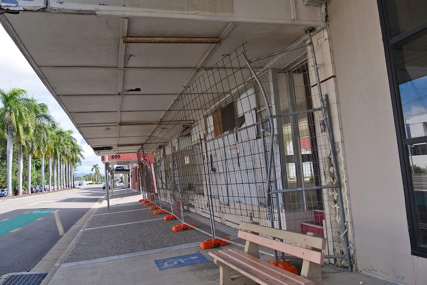 An unused building on Flinders Street West in Townsville, it has metal mesh out the front and is in need of repair