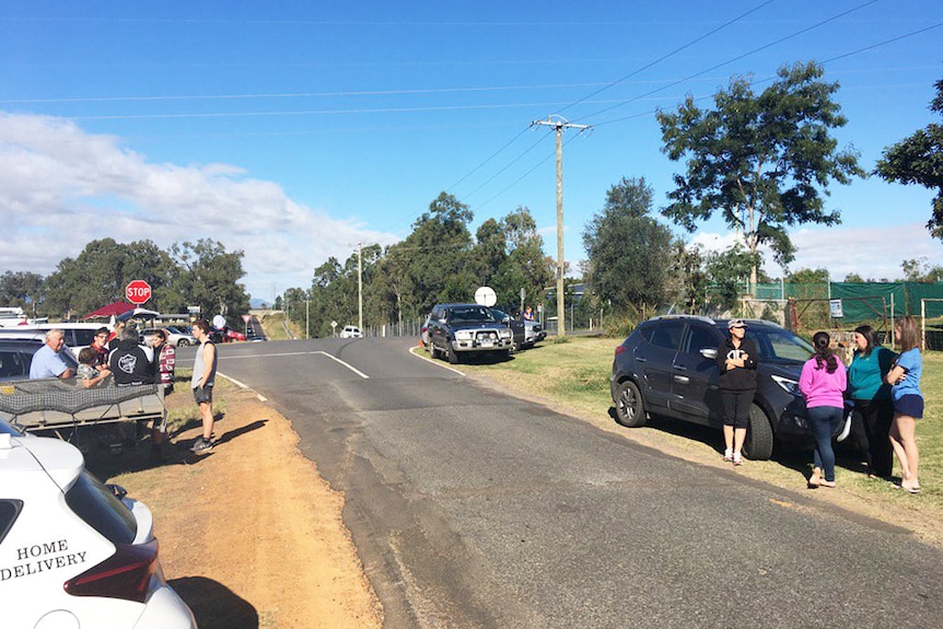 Residents wait near road blocks to get home as the siege with the gunman continues