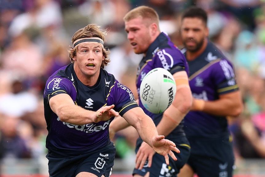 Harry Grant passes a rugby ball to his left