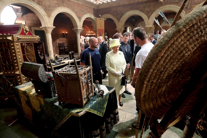 Queen Elizabeth II views props during her visit to the set of the TV series Game of Thrones.