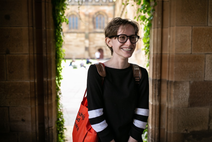 A girl stands in an archway