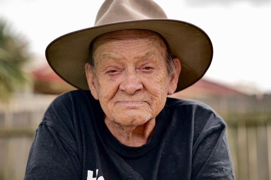 An elderly Aboriginal man wearing a wide-brimmed hat