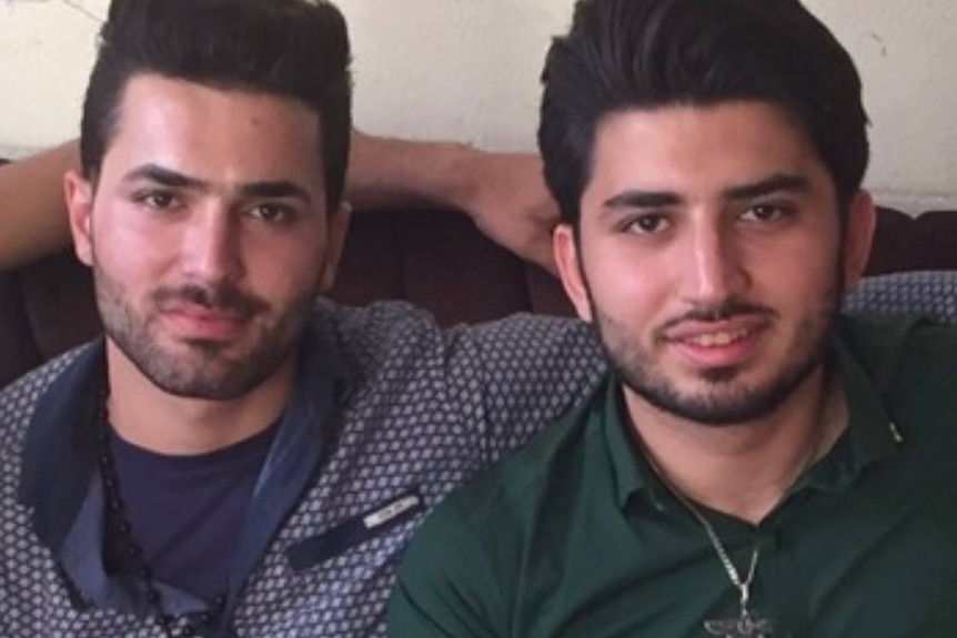 two young men at their home in iran