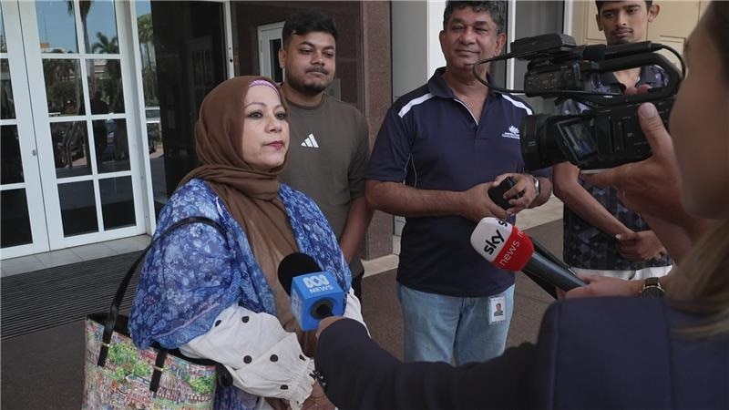 A woman speaks to media outside court