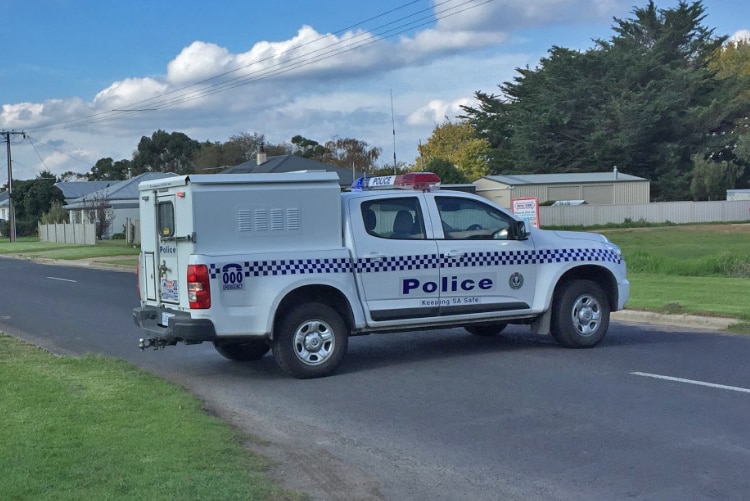 Police van at the end of a street.