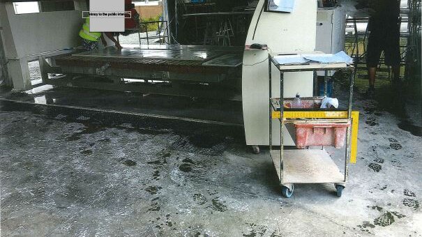 Footprints in silica dust around cutting machinery at the Marble and Granite Specialists workshop