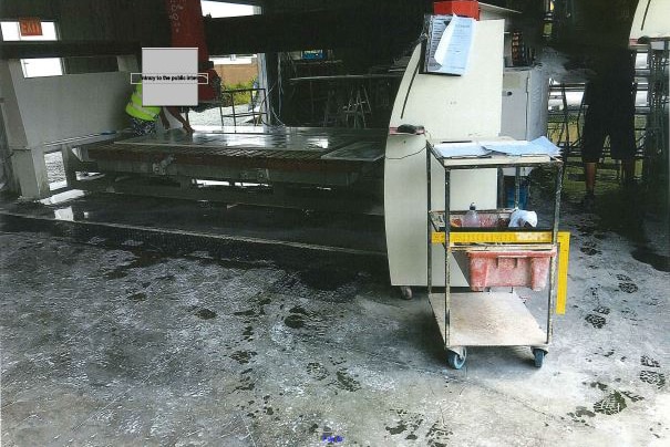 Footprints in silica dust around cutting machinery at the Marble and Granite Specialists workshop