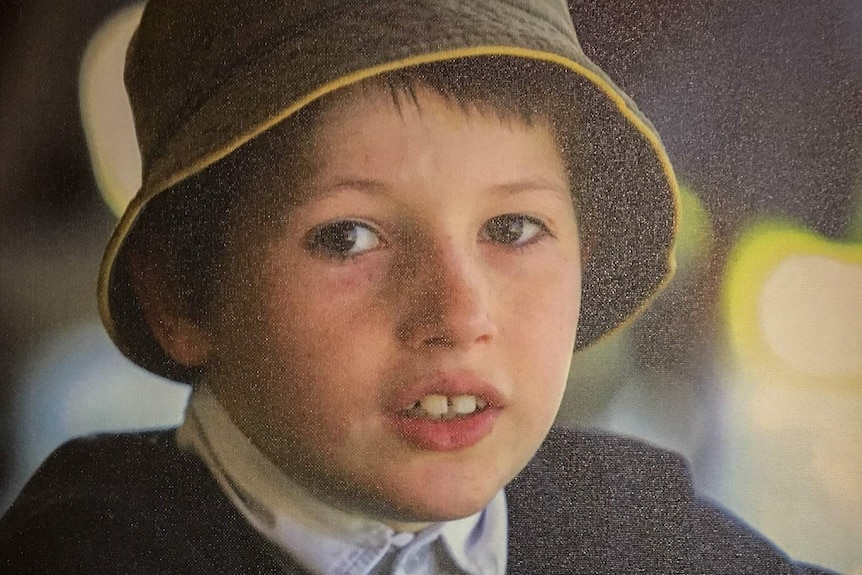 Headshot of 10-year-old Curtis Powell, wearing a hat.