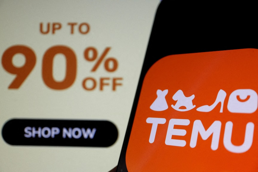 An orange logo on a phone screen that says TEMU in front of a separate computer screen showing a 90 per cent off deal.