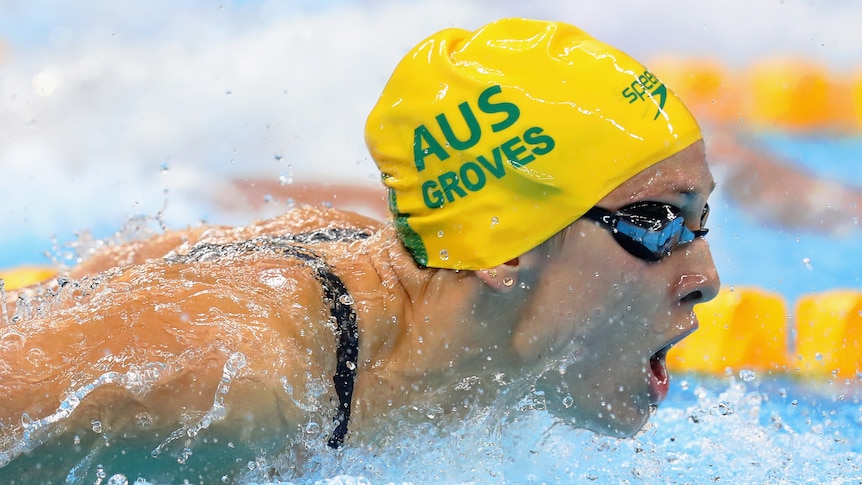 Female swimmer coming up for a breath while completing in an event 