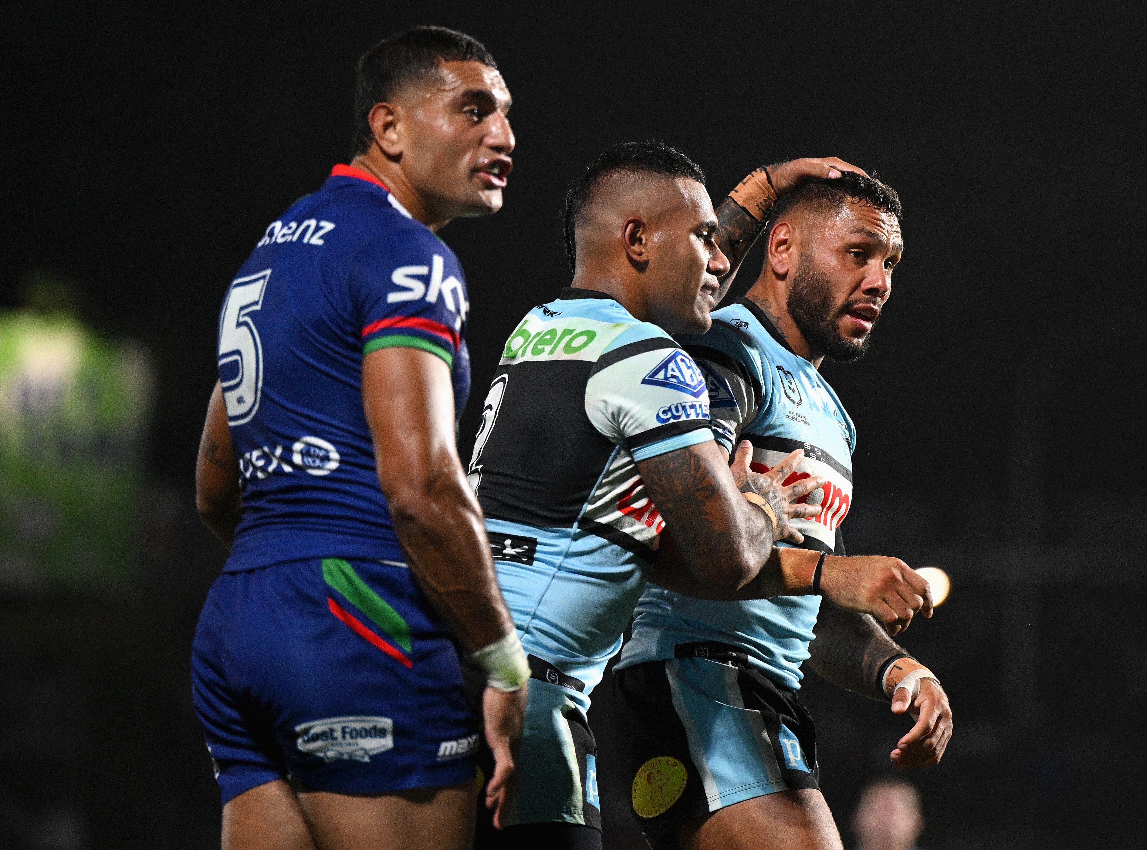 A team of rugby league player celebrate scoring a try