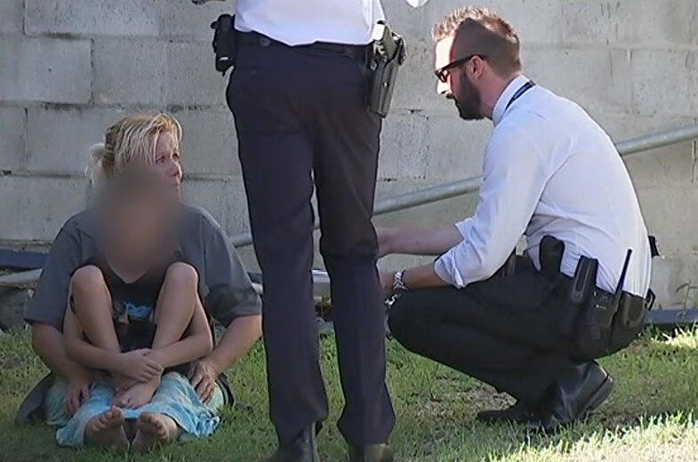 Woman speaks to detectives after a shooting at Carrara on the Gold Coast.