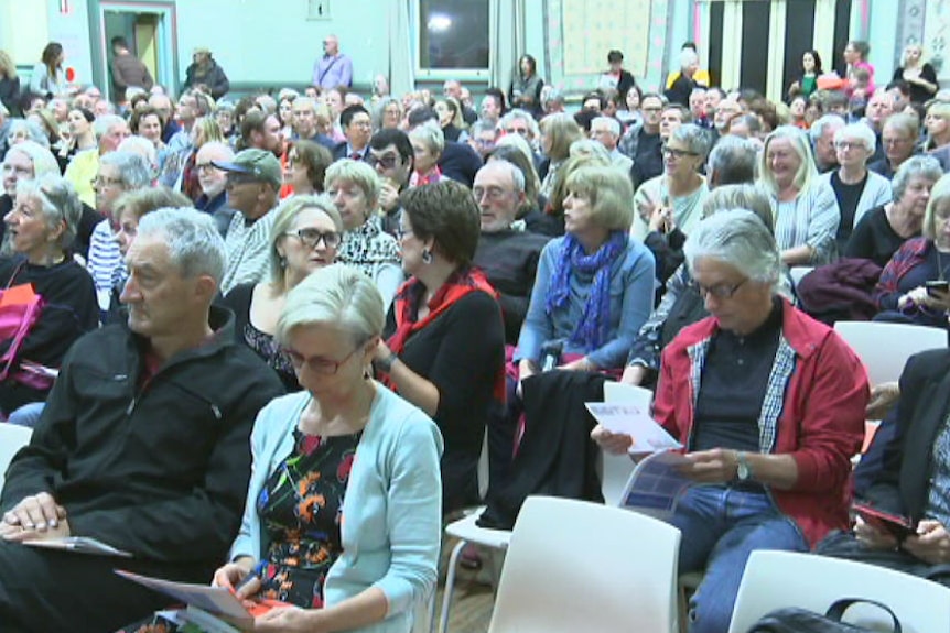 Residents gather at Balmain Town Hall to call for a halt to WestConnex construction.
