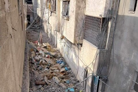 A photo of rubble filled alleyway in Gaza.