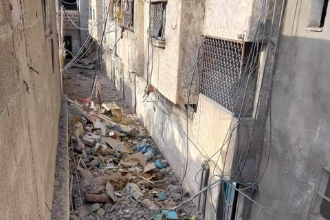A photo of rubble filled alleyway in Gaza.